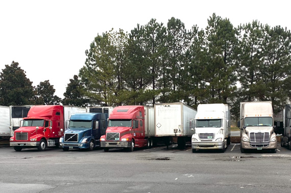 A fleet of semi trucks parked in parking lot Union City