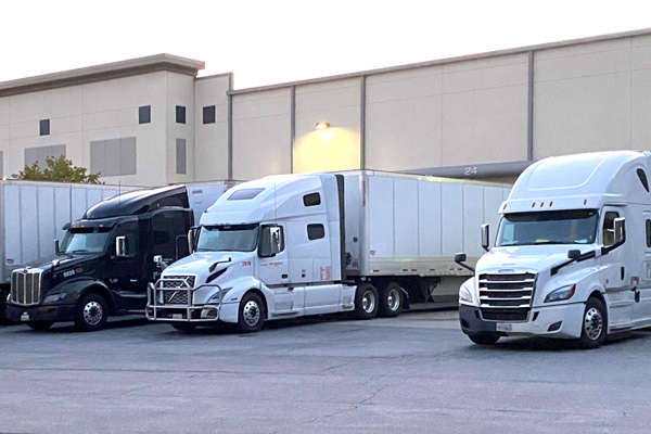 Three semi trucks parked at warehouse in Jonesboro